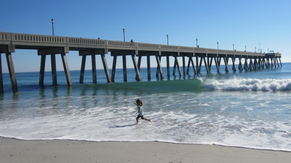 Our middle munchkin ecstatically running in the waves.